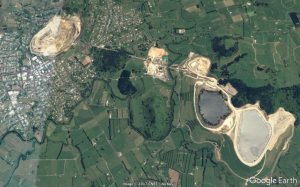 Waihi, from space, with Martha mine pit at left and tailings dams at right. Image from Google Earth 2017.